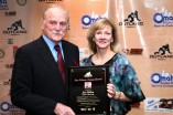 Jim Ridlon Sr., the sculptor of the Outland Trophy, and his wife pose with the Tom Osborne Legacy Award. Photo provided by the Greater Omaha Sports Committee.