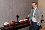 Ted Gangi of collegepressbox.com admires FWAA Awards. (Photo by Melissa Macatee)