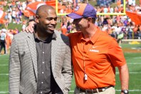 Former Alabama and NFL running back Shaun Alexander is greeted by Clemson coach Dabo Swinney at the school's 2019 spring game. Alexander was there to formally present the first Shaun Alexander/FWAA Freshman of the Year Trophy to Clemson quarterback Trevor Lawrence. Photo by Shane Sandefur.